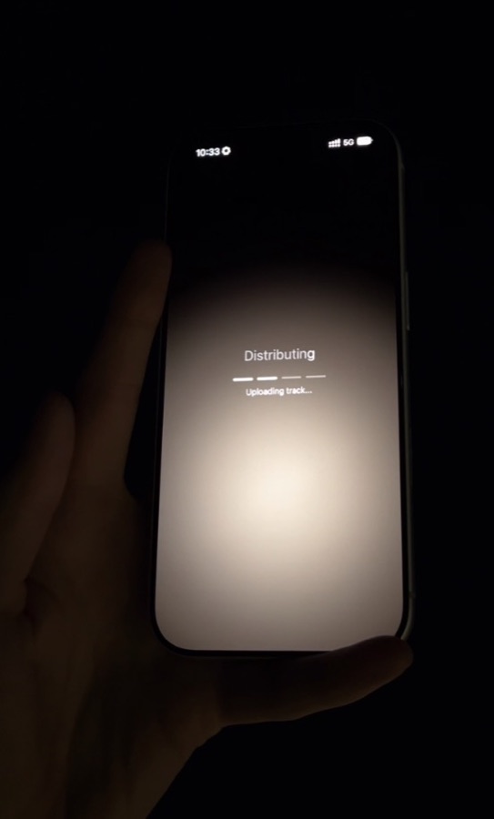 A phone held in the dark, mid-distribution